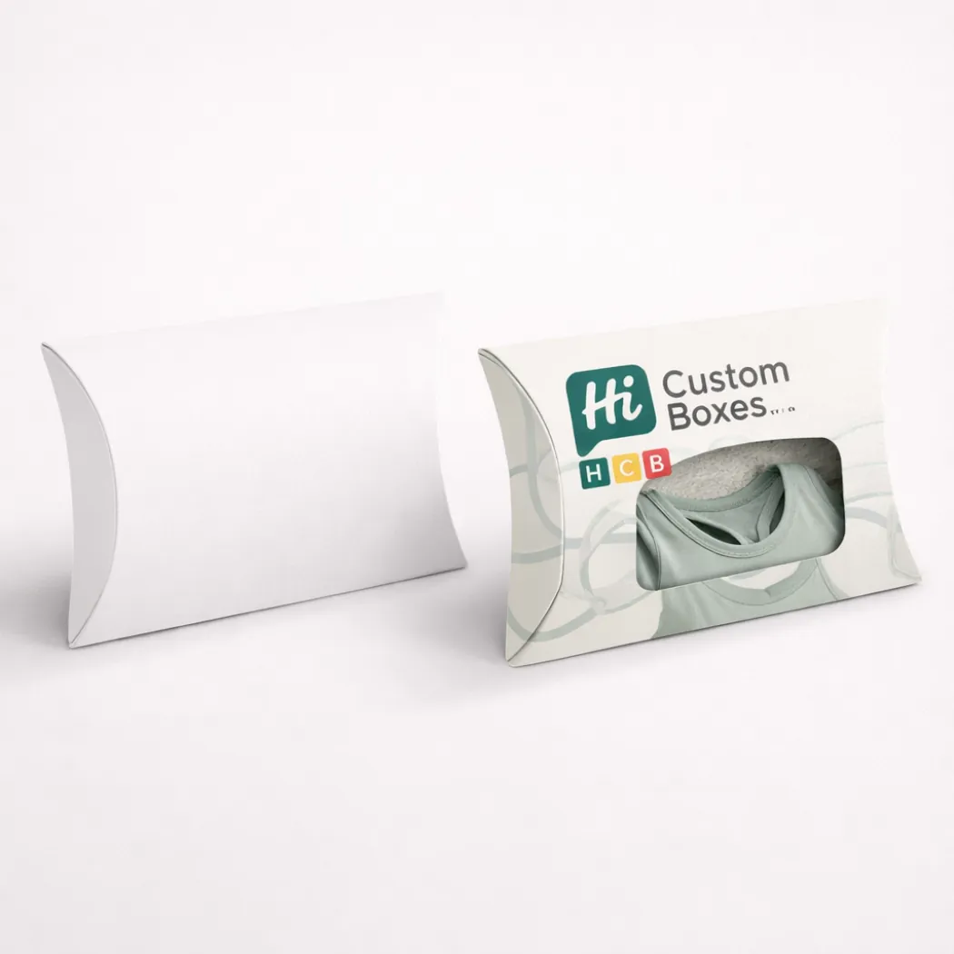 Two white pillow-shaped boxes- one plain and one with a branded window showing a bralette- class=